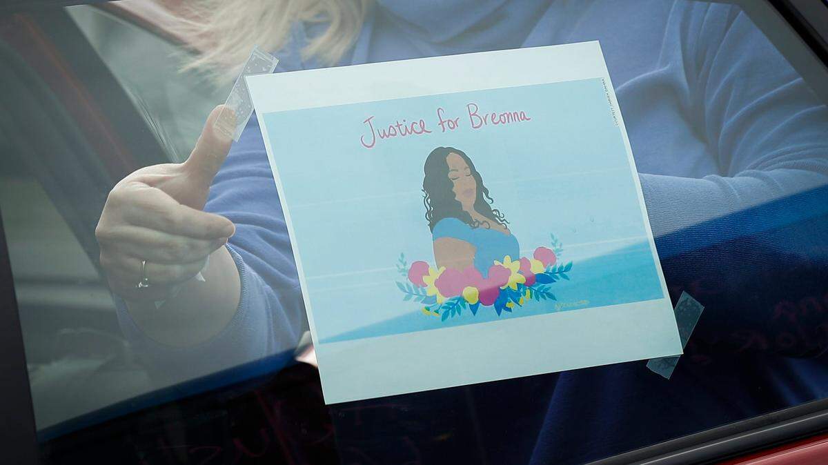 Patricia Johnson, of Lexington, Ky., decorates her car during a driving protest to remember the life of Breonna Taylor who died after being shot by police one year ago today, Saturday, March 13, 2021.