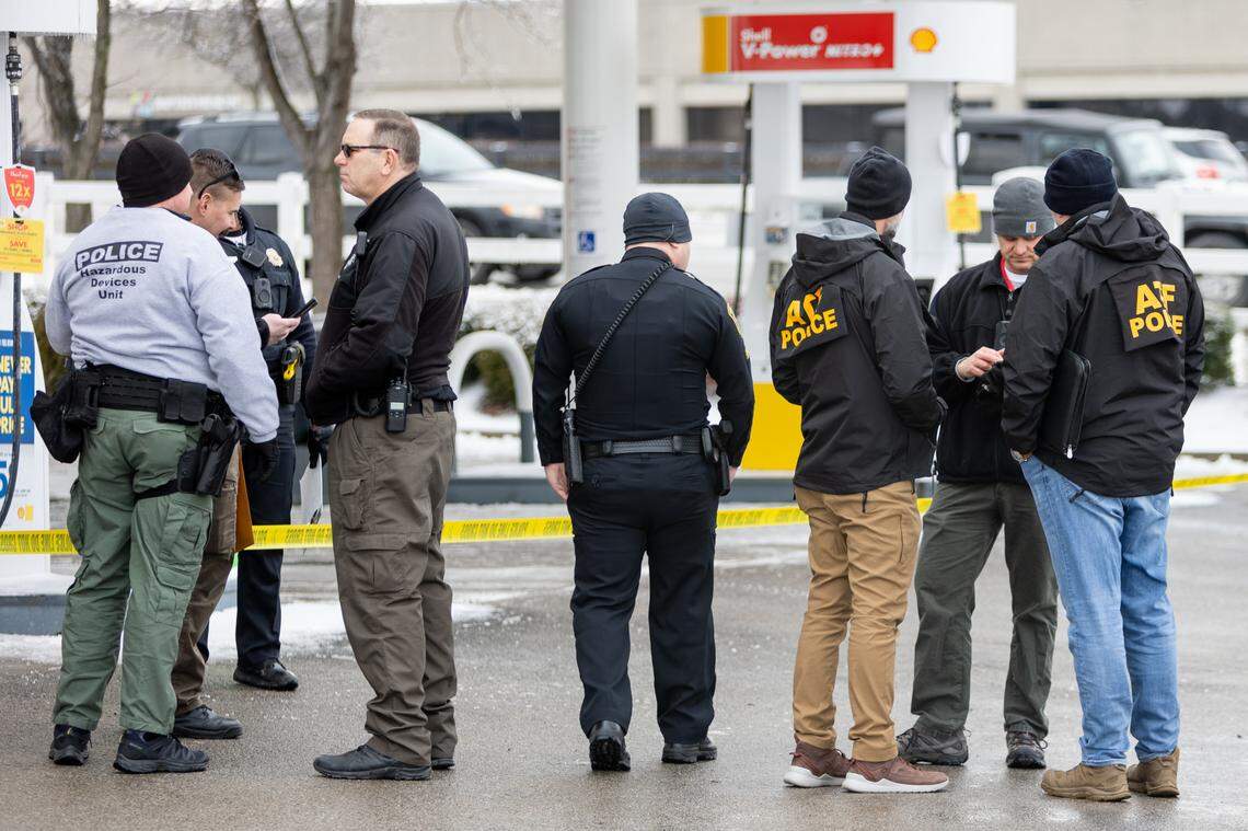 Officers work at a crime scene at a Shell gas station on Newtown Pike in Lexington, Ky., on Saturday, Feb. 5, 2022.