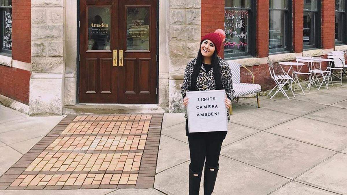 Emily Riddle stood in front of her business The Amsden at 151 South Main Street in Versailles. Part of the building will be used to film Drew Barrymore’s movie “The Stand-In” next week.