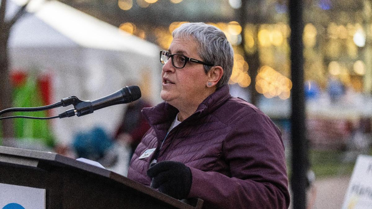 Mindy Haas, executive director of the Jewish Federation of the Bluegrass, speaks about the Shine The Light initiative, which brings awareness of antisemitism in America, at Triangle Park during the third night of the second annual downtown Hanukkah Celebration, December 20, 2022.