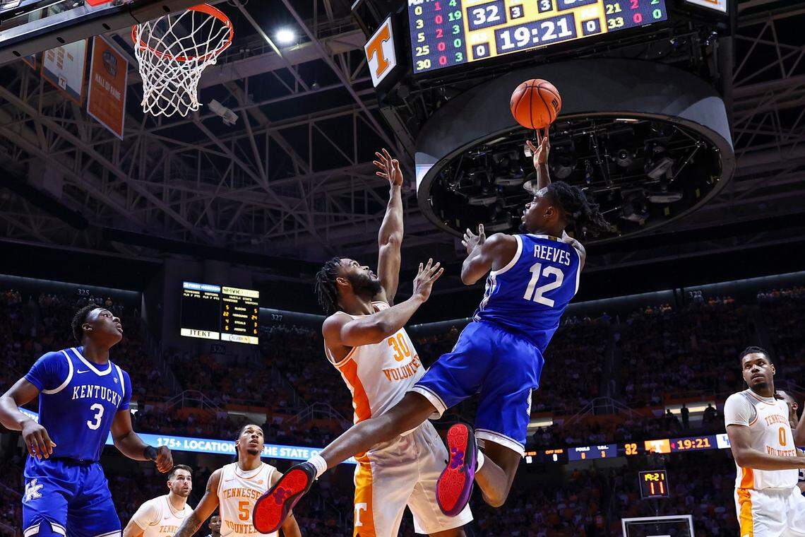 Kentucky Wildcats guard Antonio Reeves (12) tosses up the ball to score over Tennessee Volunteers guard Josiah-Jordan James (30) during the game at Thompson-Boling Arena in Knoxville, Tn, Saturday, March 9, 2024.