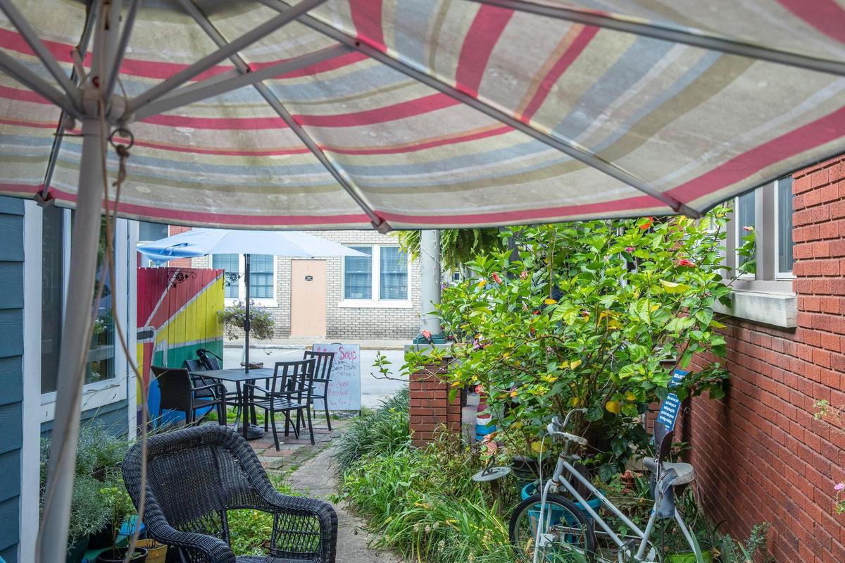 A garden area offers outdoor seating at High on Art & Coffee at 523 East High St. in Lexington, Ky., on Thursday, Oct. 21, 2021. While the inside of the shop is currently closed to customers because of COVID-19 precautions, the garden area has tables, chairs, colorful art and benches.