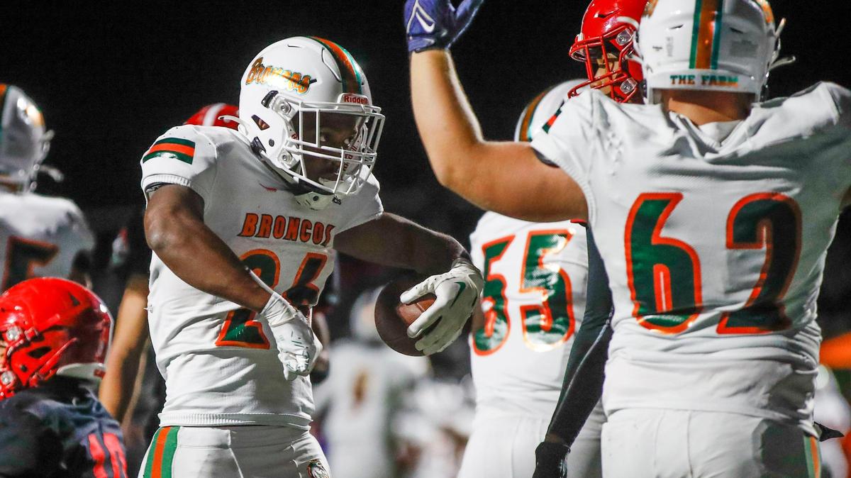 Frederick Douglass Broncos Davaun Hart (26) celebrates making a first down against the Scott County Cardinals while rushing with the ball during the game at Birds Nest Stadium at Great Crossing High School in Georgetown, Ky., Friday, September 23, 2022.