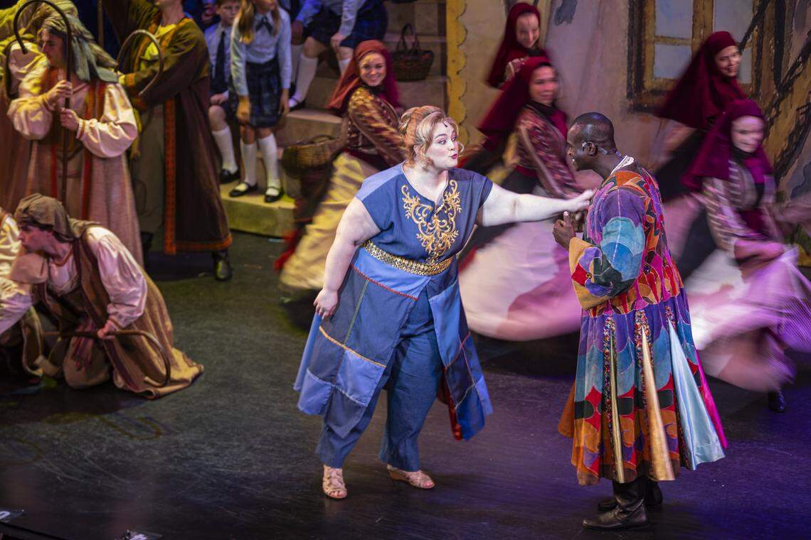 Audrey Belle Adams, center, talks with Darien Sanders while other actors dance around them during a rehearsal of Joseph and The Amazing Technicolor Dreamcoat on Monday, July 28, 2025, at the Lexington Opera House in Lexington, Ky.
