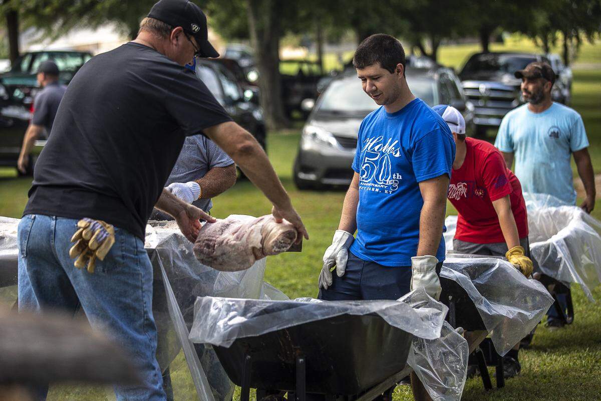 Pork is loaded into wheelbarrows to be transported to the barbecue pits on the grounds of St. Jerome Catholic Church in Fancy Farm, Ky., Friday, Aug. 2, 2019, in preparation of the Fancy Farm Picnic. Nine tons of pork and mutton are being prepared.
