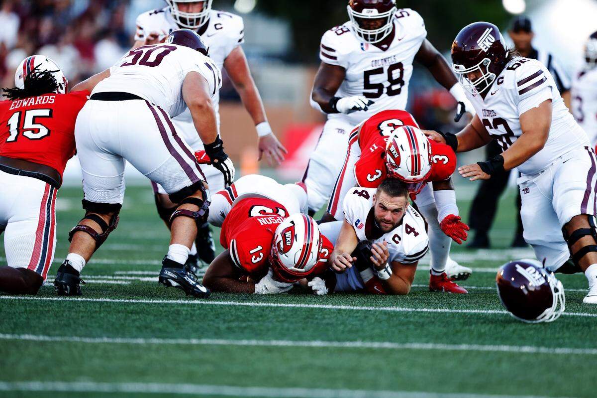 Eastern Kentucky graduate student quarterback Matt Morrissey fumbles the ball after being sacked by Western Kentucky’s defense during the Battle of the Bluegrass between EKU and WKU at Houchens Industries–L. T. Smith Stadium in Bowling Green, Ky., on Saturday, Sept. 7, 2024.