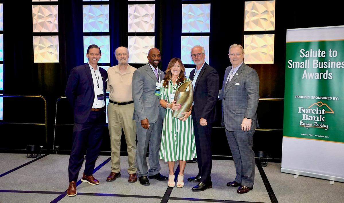 Drew Amman, of WLEX-TV; local artist Wyman Rice; Larry Forester, of Forcht Bank; DV8 Kitchen co-owners Diane and Rob Perez, and Commerce Lexington president and CEO Bob Quick at the Commerce Lexington Salute to Small Business Awards Luncheon presented by Forcht Bank on Friday.