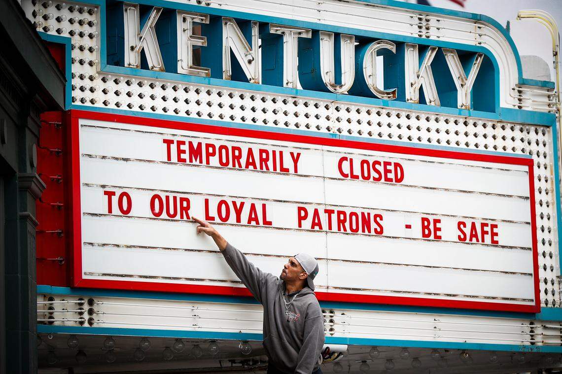 Harry Powell, of Lexington, Ky., works to change the marquee at the Kentucky Theatre in Lexington, Ky., Wednesday, March 18, 2020. The Kentucky Theatre closed on Wednesday following an executive order from Gov. Andy Beshear urging all public-facing businesses including movie theaters and gyms to close to help fight the spread of coronavirus.