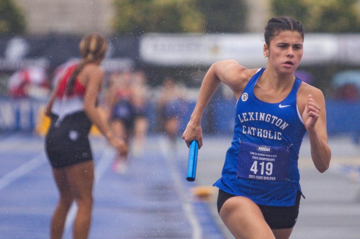 Lexington Catholic’s Anna Dawahare runs in the rain while competing in the 4 by 800-meter relay during the Class 2A track and field championships.