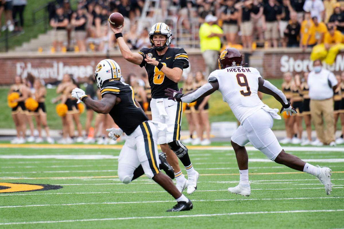 Missouri quarterback Connor Bazelak, center, throws a pass to teammate Tyler Badie, left, in the Tigers’ 34-24 opening win over Central Michigan. Bazelak completed 21 of 31 passes for 257 yards and two touchdowns in the win.