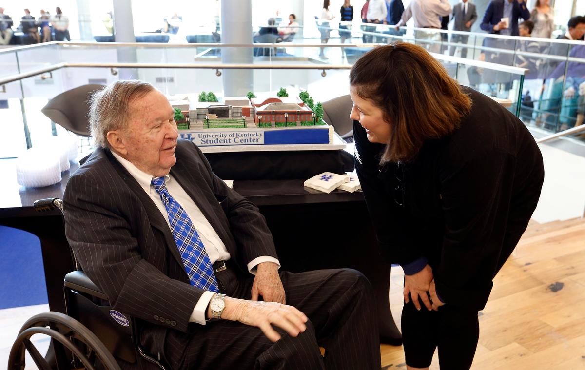 Carol Martin "Bill" Gatton, left, talked with Brandi Romines, who made the replica cake in the background, before a Monday morning ceremony where it was announced the new student center will be officially named The Gatton Student Center at the University of Kentucky in his honor. The ceremony was held near the Social Staircase in the new $201,250,000 student center on Avenue of Champions. 