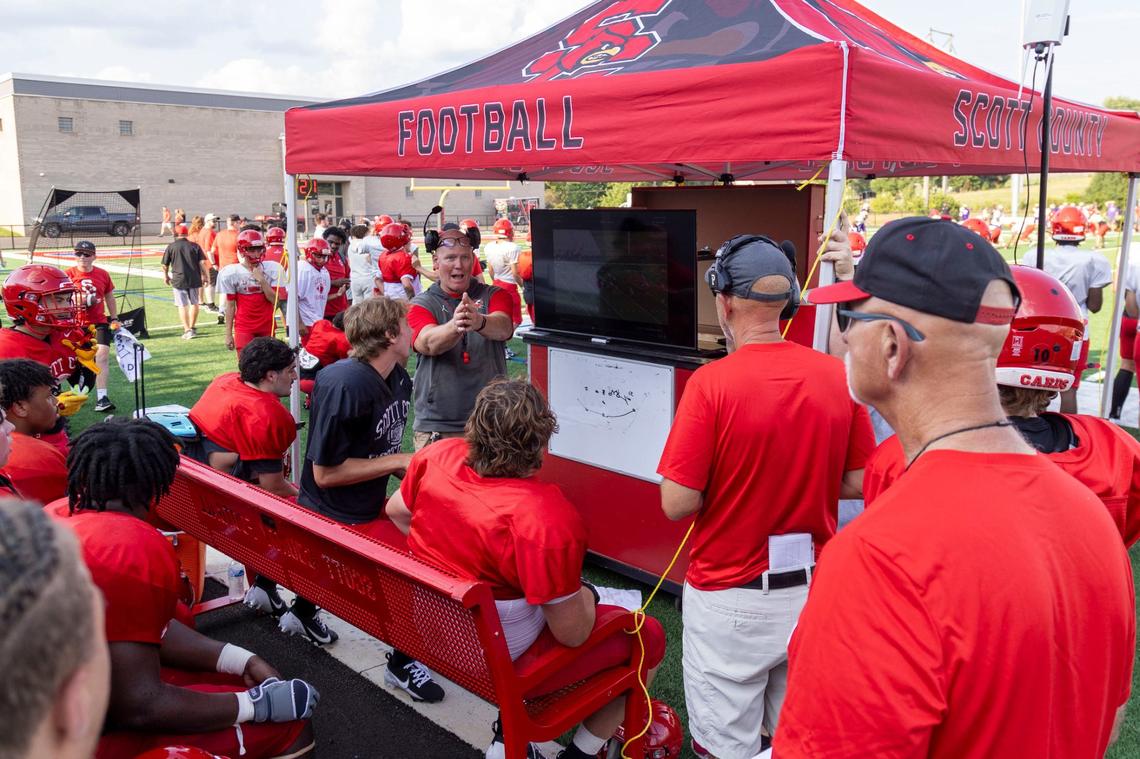 Scott County head coach Jim McKee reviews the previous play with the team during a scrimmage against Bowling Green on Aug. 9 at Scott County High School in Georgetown.