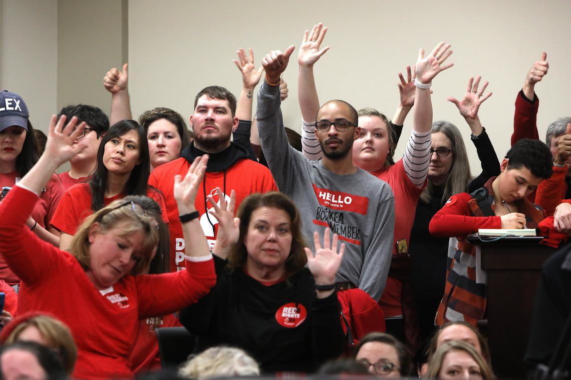 Educators waved hands to show their approval so they wouldn’t disrupt the proceedings Thursday during a House committee meeting about HB 525 at the State Capitol in Frankfort. Photo by Matt Goins