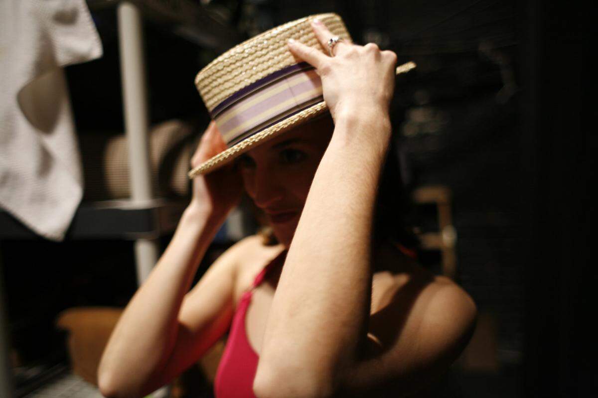 Lyndy Franklin tries on a hat during rehearsal for “A Chorus  Line.”