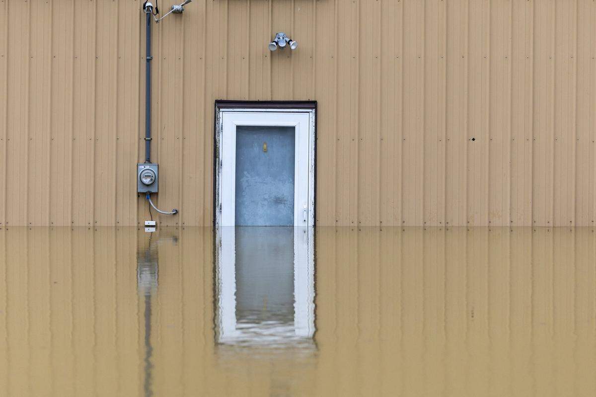 Water rises by a building in Monterey, Ky., as the Kentucky River floods on Sunday, April 6, 2025.
