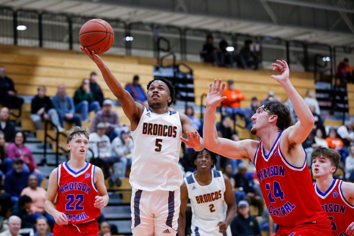 Frederick Douglass’s Tylon Webb (5) drives to the basket against Madison Central’s Robby Todd (24) during a game in Lexington on Jan. 20.
