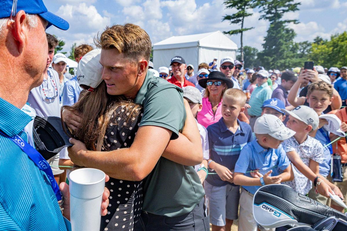 William Mouw, center, hugs his wife, Hannah Mouw, after finishing the final round of the ISCO Championship on Sunday, July 13, 2025, at Hurstbourne Country Club in Louisville, Ky.
