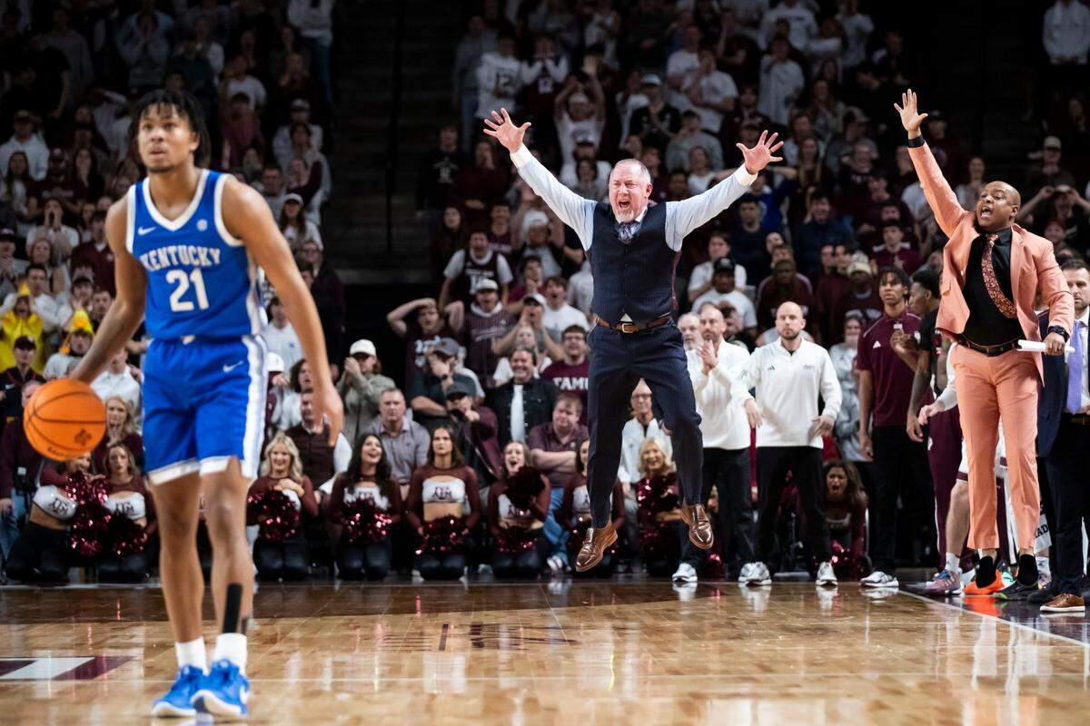 Texas A&M head coach Buzz Williams jumps up and down on the sideline in overtime during Saturday’s game against Kentucky.