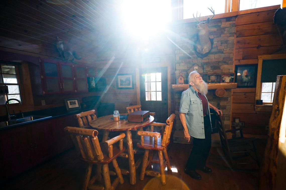 Jerry Tucker, of Liberty, Ky., pauses while walking through a log cabin built for him and his wife Sandy Tucker, who died from ovarian and colon cancer in June 2007 at Galilean Home in Liberty, Monday, Dec. 20, 2021. The cabin was originally built as a retirement home for the Tucker’s, but Sandy passed away before it was completed.