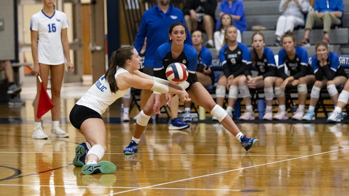 Lexington Catholic’s Maddy Warner, left, went for a dig during the Knights’ 3-0 win over West Jessamine at Lexington Catholic High School on Thursday.