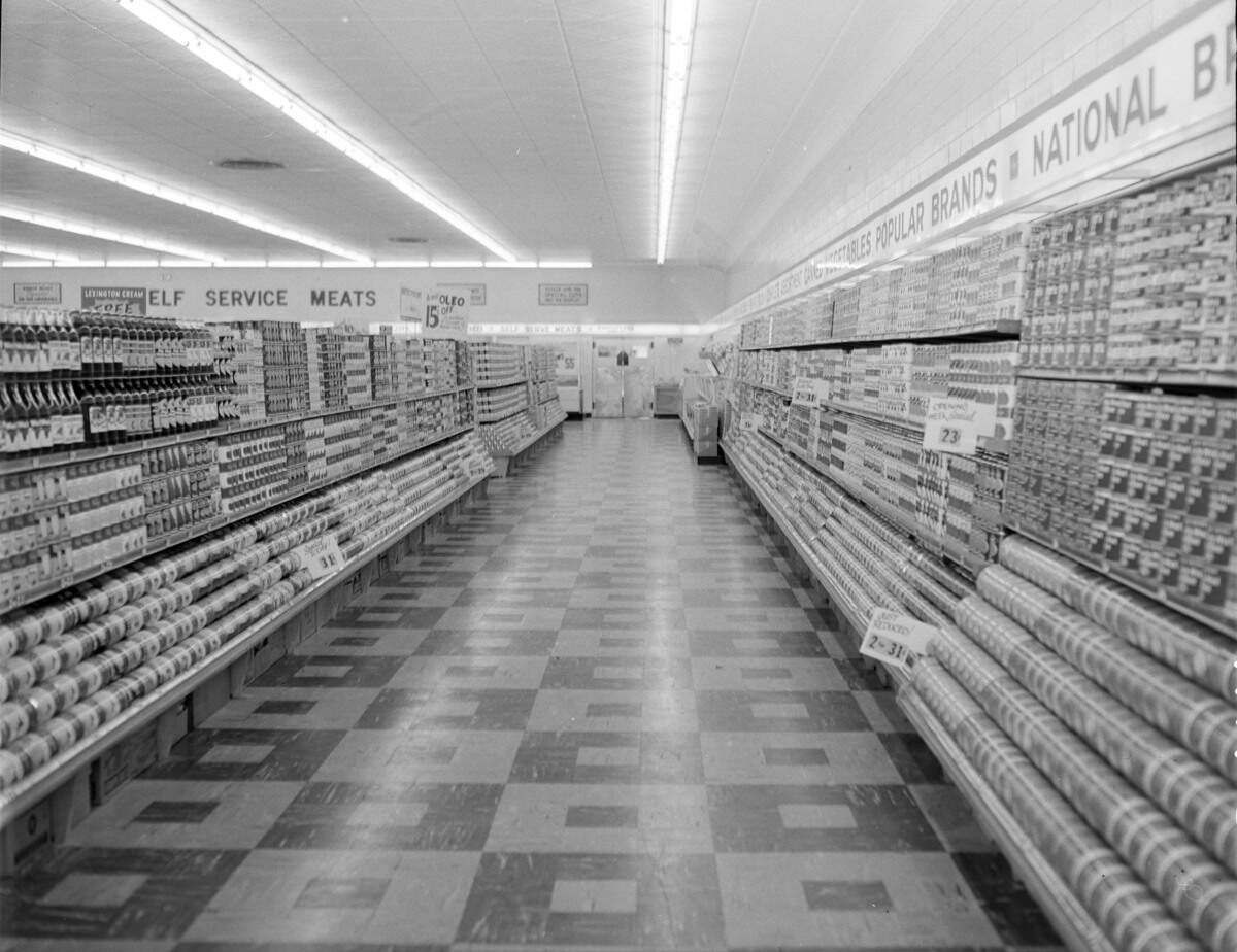 A canned-lined aisle inside a new Kroger supermarket before it opened on Sept. 8, 1952 on the Southern U-Pass (today known as Southland Drive). When it opened, the store was the largest in Kentucky and the third-largest Kroger grocery in the nation. It’s parking lot held 458 cars and the store was 100% self serve. Its aisles were 12 feet wide, and the store had a dietetics food department featuring sugar-free and saltless canned fruits and vegetables. There were six electric conveyor-equipped checkout lines. At the time, the largest store was in Kansas City, followed by Detroit.