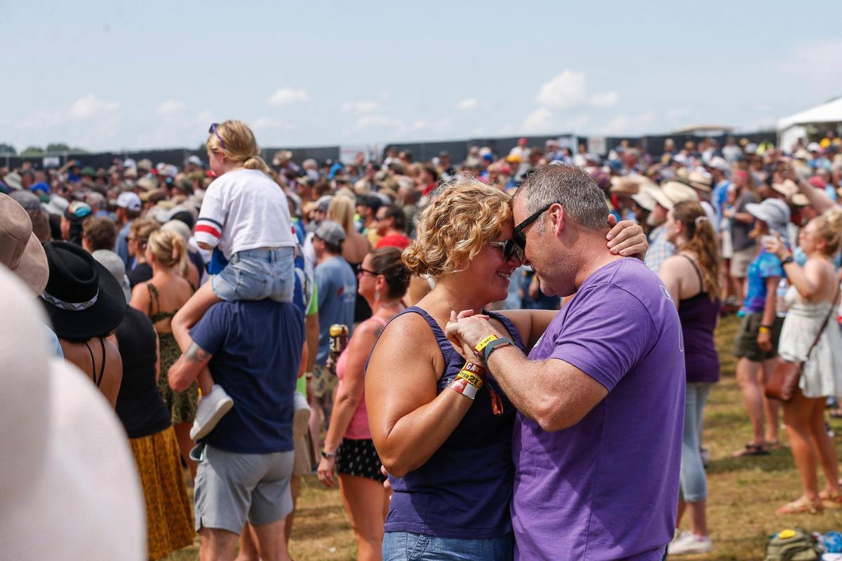 Paul Allison and Christina Smith dance and listen to shows during the second day of Railbird Festival at Keeneland racetrack in Lexington, Ky., Sunday, August 29, 2021.