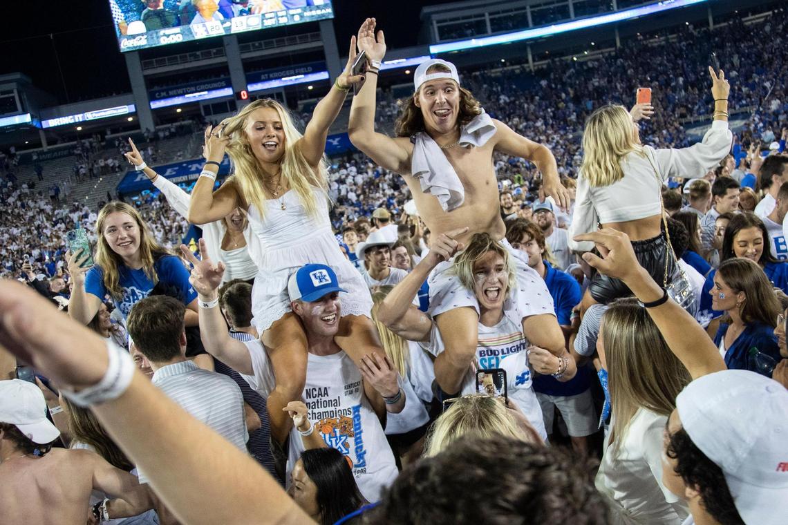 Students rush onto the field to celebrate after the Kentucky Wildcats defeated the Florida Gators after defeating the Florida Gators during the game at Kroger Field in Lexington, Ky., Saturday, October 2, 2021.