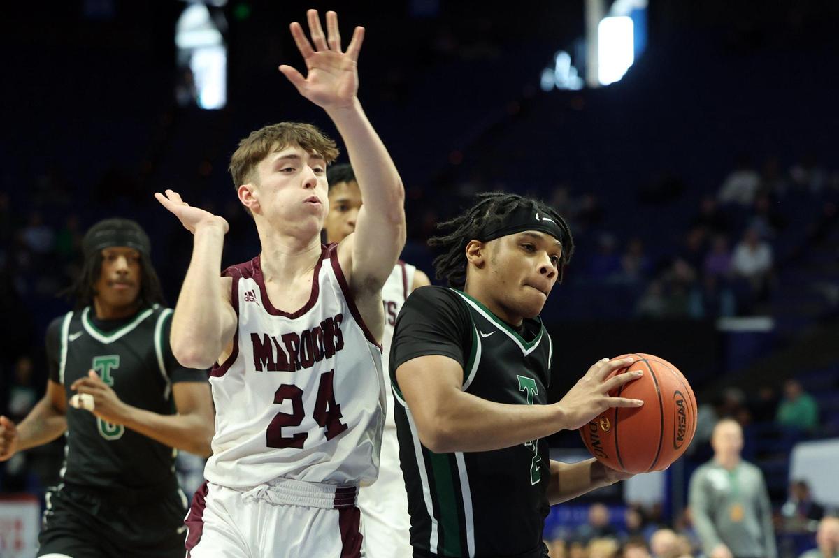 Trinity’s Andrae Vasser, right, drives against Pulaski County’s Will Blankenship (24) during Thursday night’s game in Rupp Arena. Vasser led the Shamrocks with 19 points.