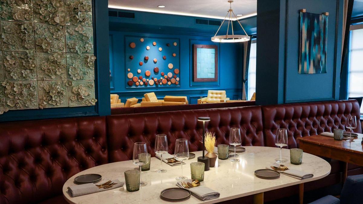 A new marble table in the dining room at Crafted at Boone Tavern, Monday, July 14, 2025, the new restaurant at the Historic Boone Tavern Hotel in Berea, Ky. The table is surrounded by a new read leather booth.