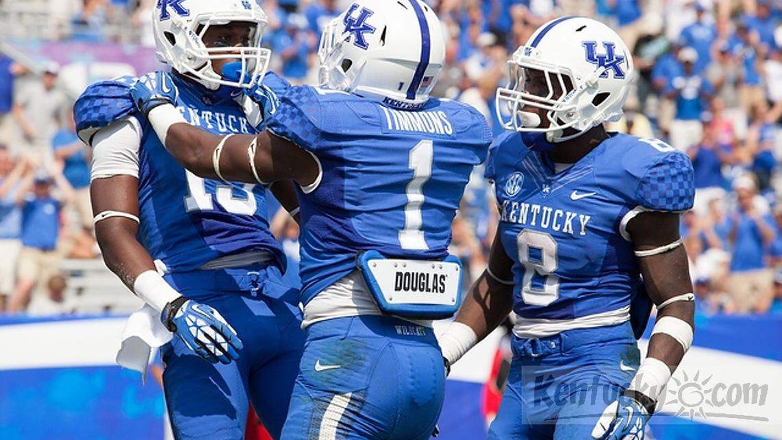 Ryan Timmons, center, and Javess Blue (8) celebrated with wide receiver Jeff Badet after Badet scored a touchdown for Kentucky on Sept. 7 against Miami (Ohio.)