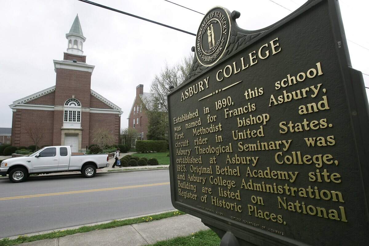 Sign on the Asbury College side of the road looking at the Asbury Theological Seminary campus in Wilmore, Ky.