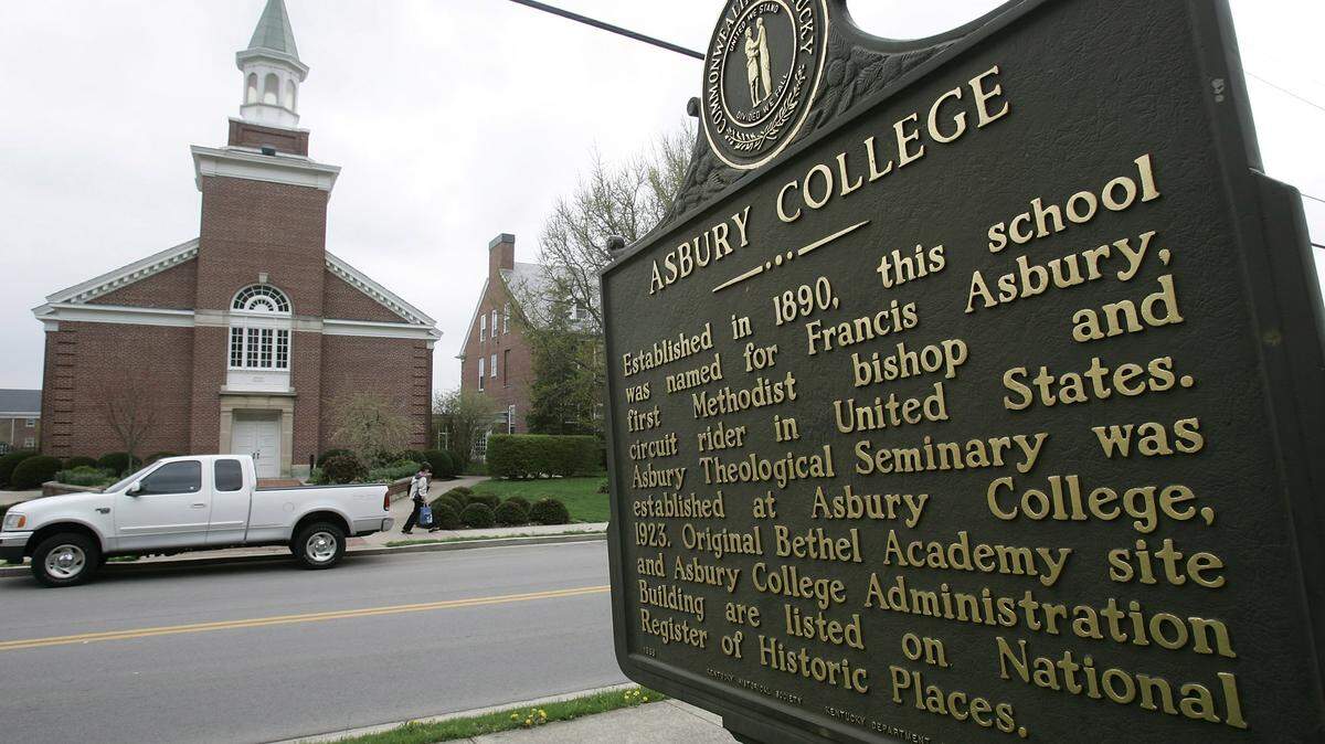 Sign on the Asbury College side of the road looking at the Asbury Theological Seminary campus in Wilmore, Ky.,