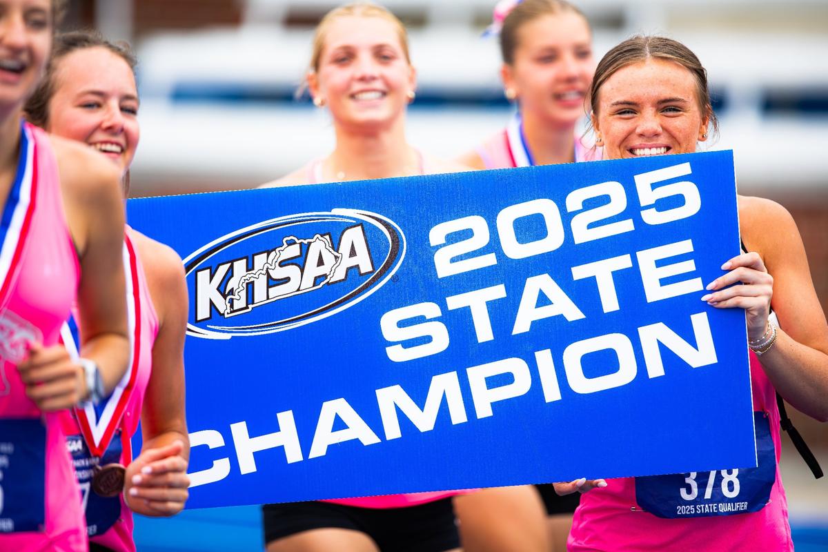 Lilly Meyer, right, and her teammates celebrate Lexington Christian’s Class A girls state championship on Thursday. This school year, LCA’s girls won team state titles in cross country plus indoor and outdoor track.