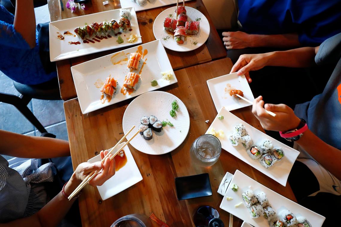 The Tyler family shares dinner at Zen Sushi & Sake in Lexington, Friday July 26, 2019. Over the past year the Tyler family have been eating “alphabet dinners” choosing restaurants from a-z staring with Asian Wind and ending with Zen Sushi & Sake.
