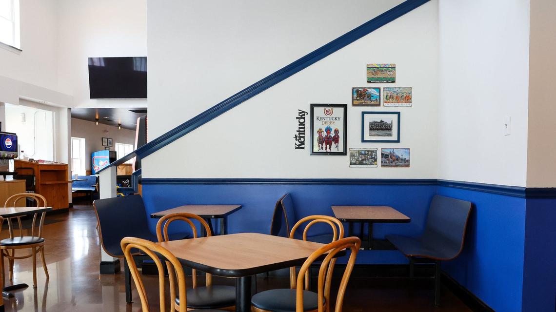 UK blue tables and booths at the new Tolly-Ho. Stairs lead to an upstairs place that can be reserved for private events.