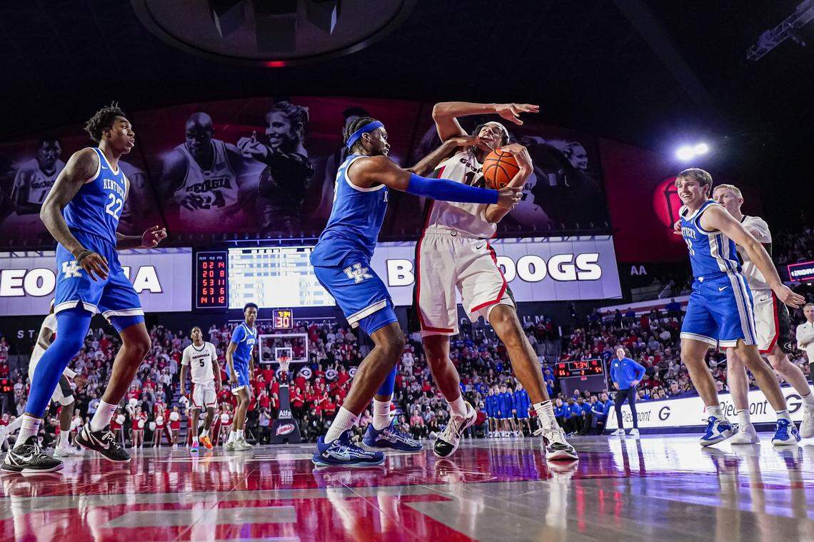 Jan 7, 2025; Athens, Georgia, USA; Georgia Bulldogs forward Asa Newell (14) and Kentucky Wildcats forward Ansley Almonor (15) fight for a rebound during the second half at Stegeman Coliseum. Mandatory Credit: Dale Zanine-Imagn Images