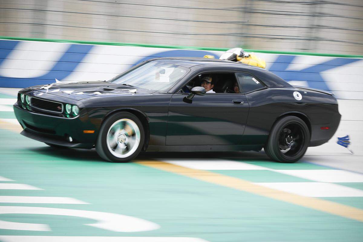 Graduating Gallatin County High School senior Mayte Marcelino is drive around the track by her brother Abel Marcelino, during a “victory lap” Kentucky Speedway in Sparta, Saturday, May 23, 2020. Saturday’s lap around the track was part of Gallatin County’s graduation ceremony.