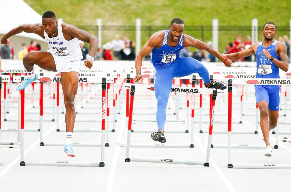 Kentucky’s Daniel Roberts, center, and Tai Brown, right, competed against Florida’s Grant Holloway, left, during the 2019 SEC Outdoor Track and Field Championships. Roberts won the title.