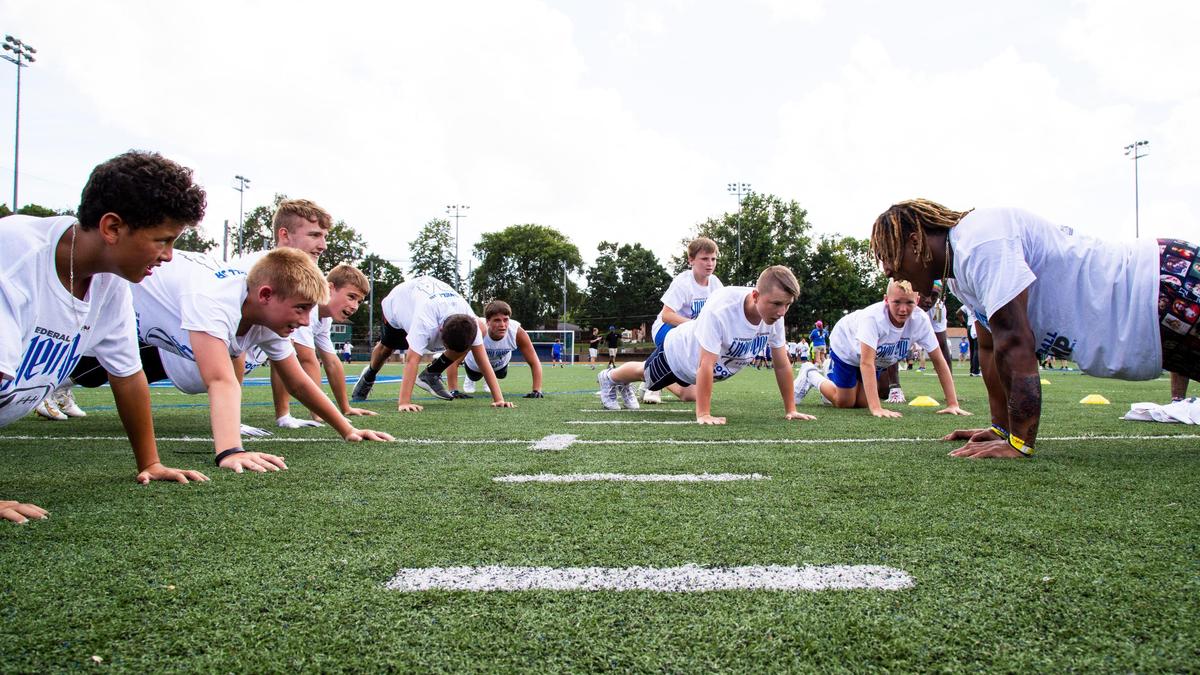 Benny Snell, right, put his campers through their paces during Tuesday’s event at Lexington Catholic High School.
