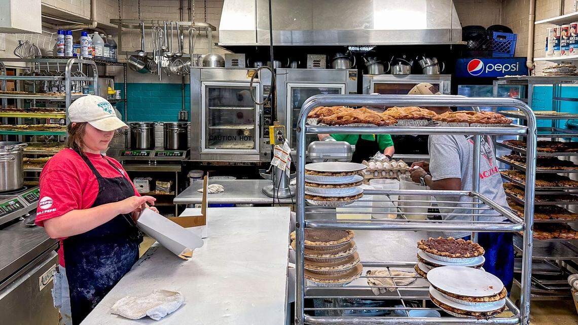 An employee boxes pies at Missy’s Pies, Etc., Wednesday, July 10, 2024 at the local bakery at 502 East High Street in Lexington, Ky.