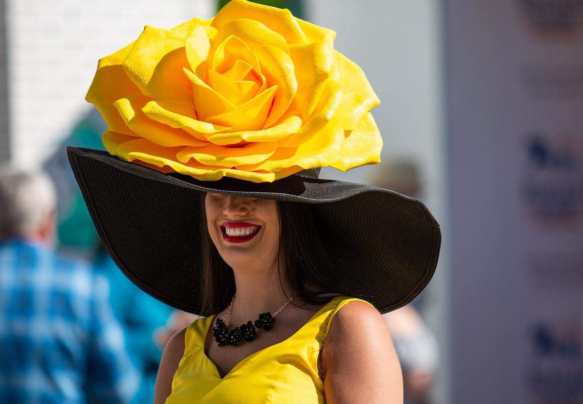 Tiffany Pierce of Columbus, Ga., peers out from beneath her derby hat while walking through the paddock area at Churchill Downs in Louisville, Ky., during the 147th Kentucky Derby on Saturday, May 1, 2021.