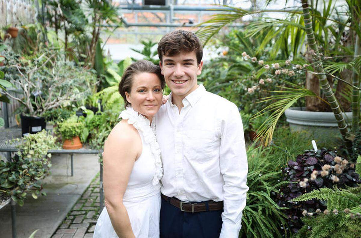 Angela Sanchez, left, stands with her son Cyrus inside the Greenhouse at the University of Kentucky. Sanchez graduated from UK with a degree in landscape architecture on Friday.