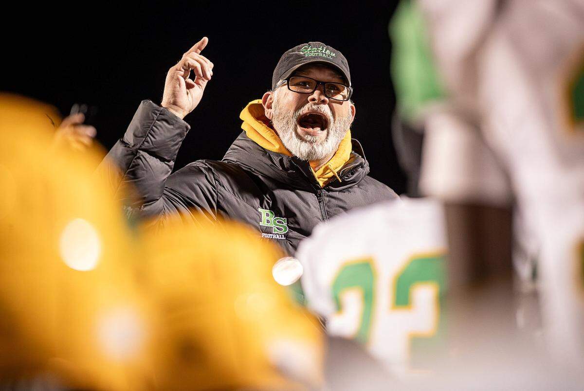Bryan Station head coach Phillip Hawkins congratulates his team after the Defenders’ victory over Ballard in the Class 6A state semifinals. Bryan Station improved to 11-3 this season and to 41-11 since Hawkins took over in 2020.