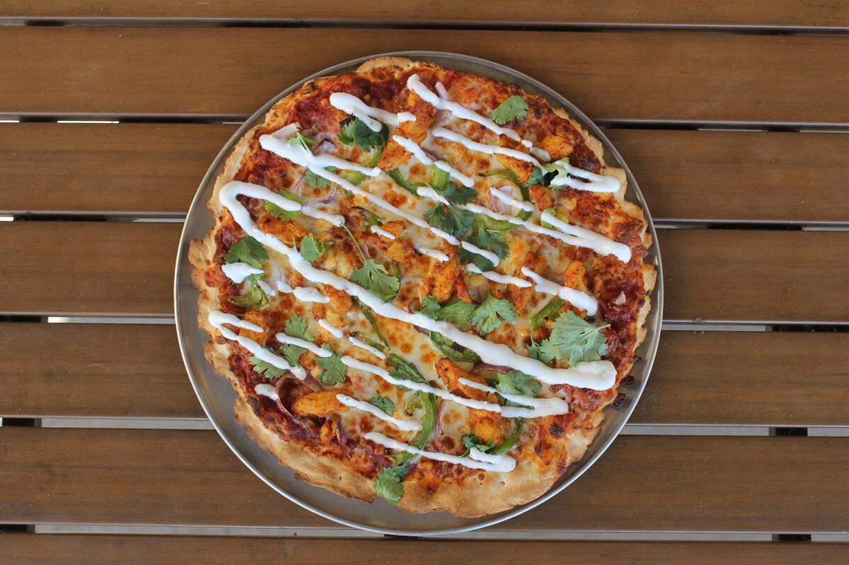Pie Five’s meat option is called Tandoor Feather and features tandoori chicken and spicy marinara, cooled with cilantro and a yogurt drizzle.