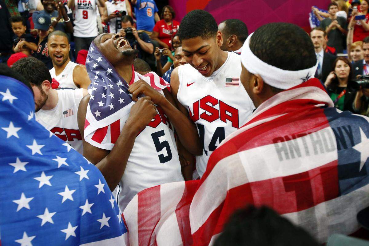 Team USA players Kevin Durant (left) , Anthony Davis (middle) and Carmelo Anthony celebrate after defeating Spain in the gold medal game at the London 2012 Olympic Games.