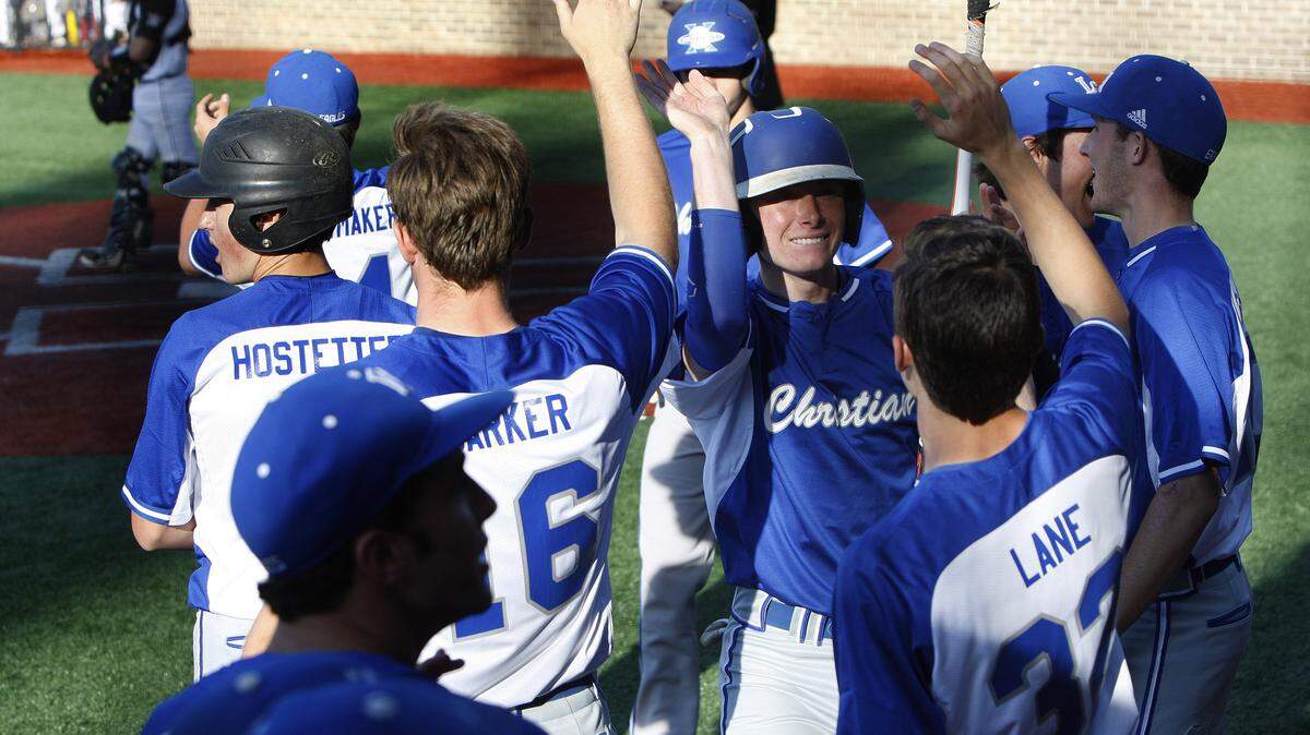 After  knocking in two runs in the first  inning,  Lexington Christian's Frederick Rupp, facing front, scored one of two runs in the second on 
a Tates Creek error Tuesday night.     