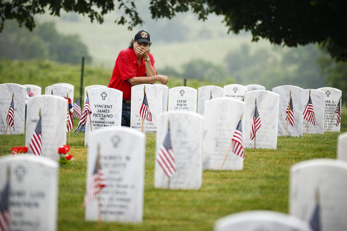 Marc Avery, of Lexington, Ky., visits the graves of his parents Calvin and Jeanne Avery during a Memorial Day ceremony at Camp Nelson National Cemetery in Nicholasville, Ky., Monday, May 27, 2019. Avery served in the U.S. Marine Corps from 1972-1975.