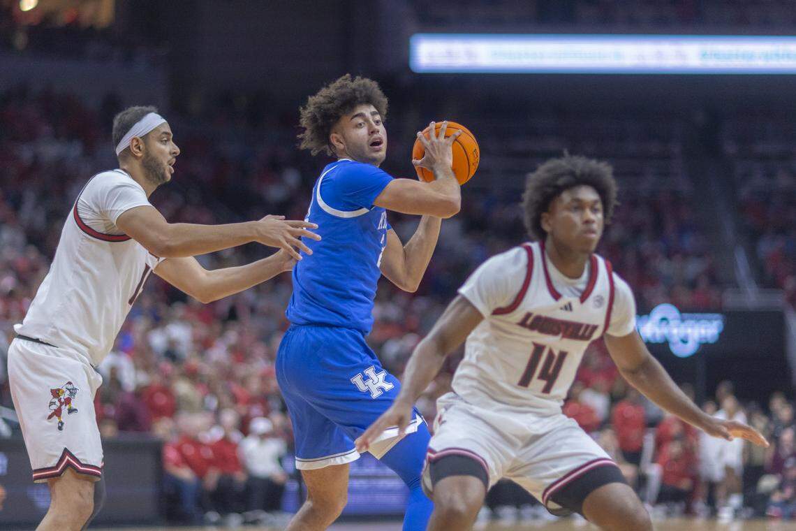 Kentucky's Malachi Moreno, center, looks to pass the ball as Louisville’s Aly Khalifa, left, and Adrian Wooley defend during last week’s loss to the Cardinals. 
