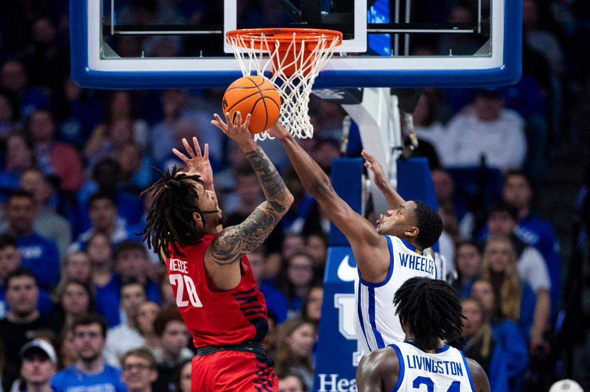 Kentucky Wildcats guard Sahvir Wheeler (2) blocks a shot by Duquesne Dukes forward Joe Reece (20) during the game at Rupp Arena in Lexington, Ky., Friday, November 11, 2022.