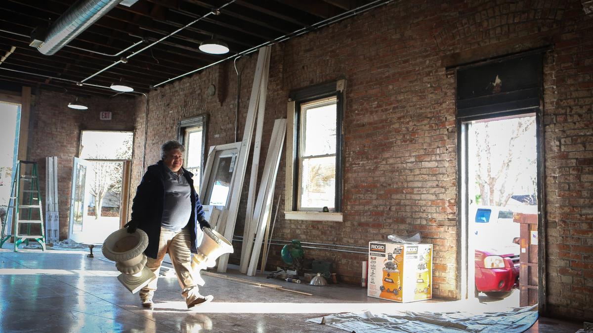 Longtime employee Pam Jenkins, who has worked at E. Stephen Hein florist since the Main St. location, moved varied urns into the new building, which is in the final stages of construction, Wednesday. E. Stephen Hein Florist moved to its new home at the corner of Second St. and Eastern Ave. in Lexington. Photo by Matt Goins